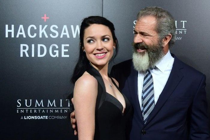 Mel Gibson and his girlfriend Rosalind Ross pose on the carpet on arrival for the special screening of the film he directed, Hacksaw Ridge, at the Samuel Goldwyn Theater in Beverly Hills, California on October 24, 2016