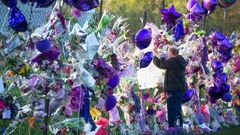A fan visits a memorial outside Paisley Park, the home and studio of Prince, in April, 2016 in Chanhassen, Minnesota