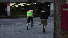 A screen grab taken from video footage shows plain clothes police officers running towards car park of the Olympia shopping mall during shooting rampage in Munich, Germany July 22, 2016.