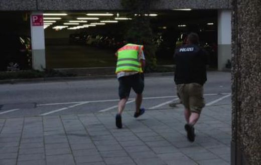 A screen grab taken from video footage shows plain clothes police officers running towards car park of the Olympia shopping mall during shooting rampage in Munich, Germany July 22, 2016.