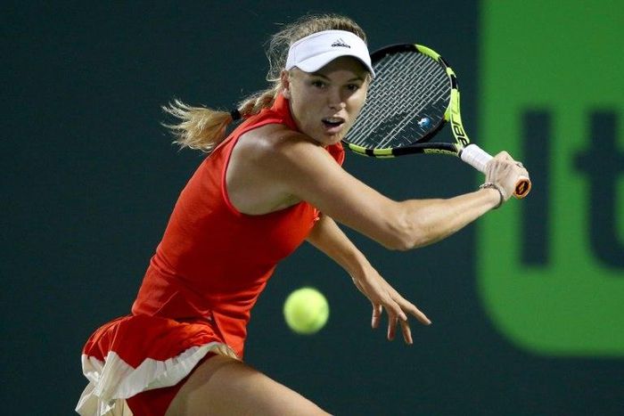 Caroline Wozniacki of Denmark returns a shot to Lucie Safarova of Czech Republic during their WTA Miami Open quarter-final match, at the Crandon Park Tennis Center in Key Biscayne, Florida, on March 28, 2017