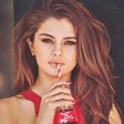 Selena Gomez sipping from a bottle of Coca-Cola.