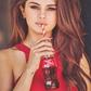 Selena Gomez sipping from a bottle of Coca-Cola.