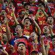 Fans of China's Guangzhou Evergrande chant slogans at supporters of Hong Kong's Eastern during an AFC Champions League football match between the two sides in Hong Kong
