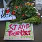 Candles, sings and floral tributes left at a vigil after a suicide bombing at an Ariana Grande concert in Manchester, England