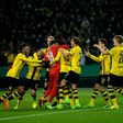 Dortmund's goalkeeper Roman Buerki celebrates with his teammates after the penalty shoot-out of the German Cup DFB Pokal round of 16 football match against Hertha Berlin February 8, 2017