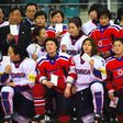 PyeongChang 2018 Organising Committee President Lee Hee-Beom (L top) poses with players from South Korea (white) and North Korea (red) after the IIHF women's world ice hockey championship match in Gangneung on April 6, 2017