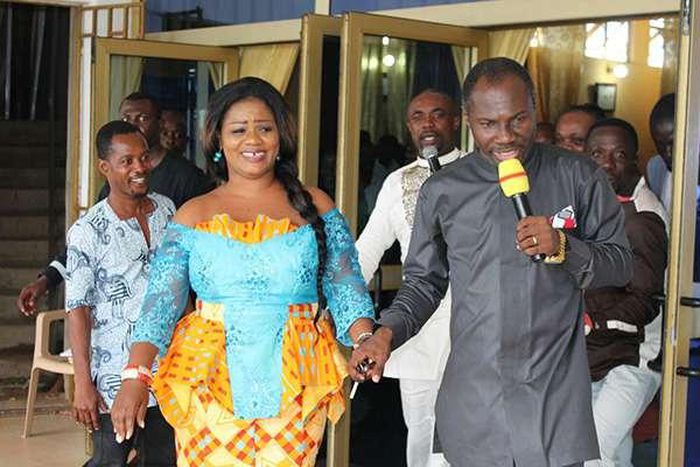 Obaapa Christy being led to her car by Prophet Badu Kobi