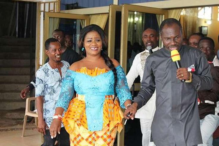 Obaapa Christy being led to her car by Prophet Badu Kobi