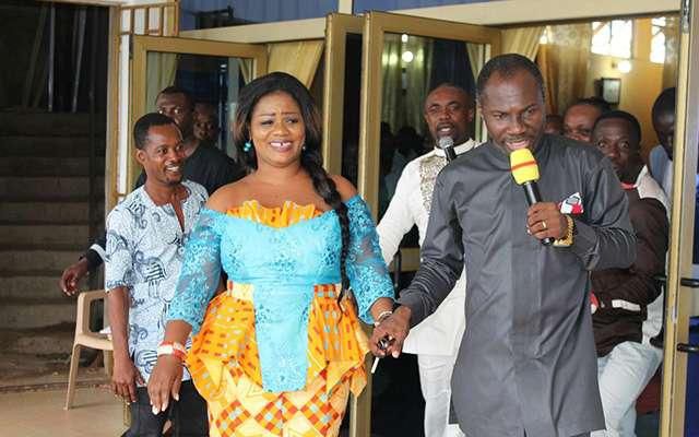 Obaapa Christy being led to her car by Prophet Badu Kobi