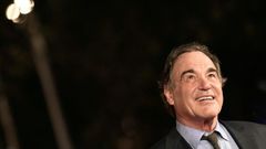 US film director Oliver Stone poses on the red carpet as he arrives for the screening of the movie "Snowden" on October 14, 2016