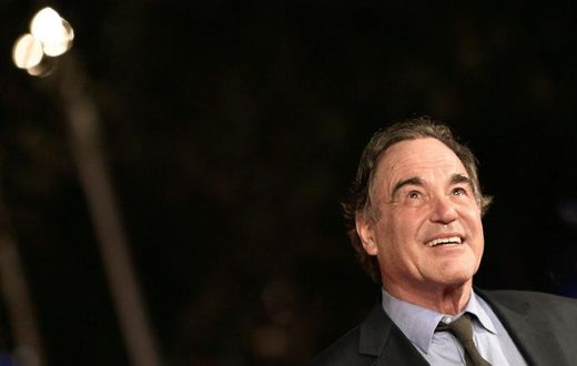 US film director Oliver Stone poses on the red carpet as he arrives for the screening of the movie "Snowden" on October 14, 2016