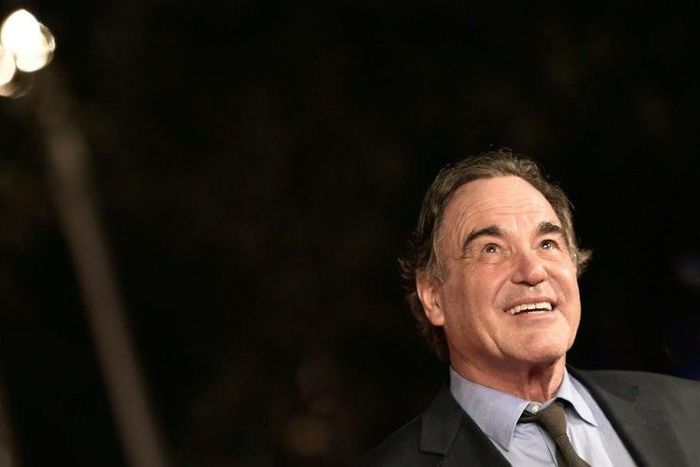 US film director Oliver Stone poses on the red carpet as he arrives for the screening of the movie "Snowden" on October 14, 2016