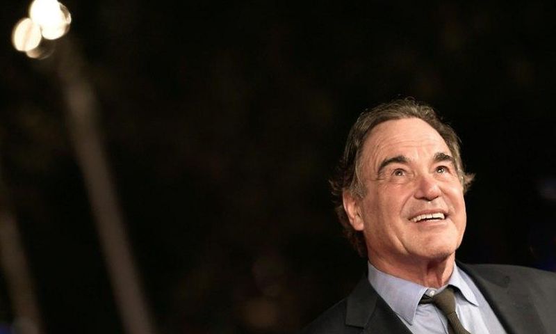 US film director Oliver Stone poses on the red carpet as he arrives for the screening of the movie "Snowden" on October 14, 2016