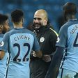 Manchester City's manager Pep Guardiola (C) congratulates Raheem Sterling, Gael Clichy and Yaya Toure after winning an English Premier League match, at the Etihad Stadium in Manchester, on December 18, 2016