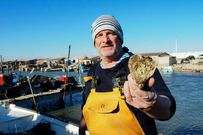 French oyster farmer Christophe Guinot shows a heart-shaped oyster that he produces and sells on Saint Valentine's Day.