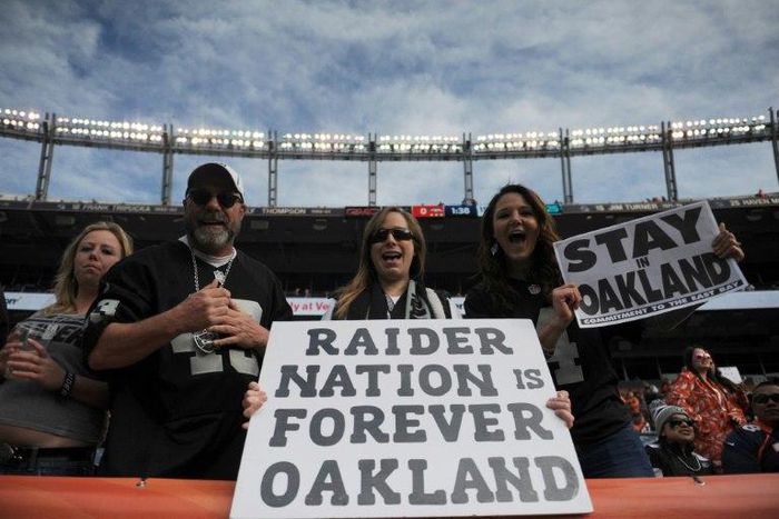 Oakland Raiders fans hold signs before the game against the Denver Broncos at Sports Authority Field at Mile High on January 1, 2017 in Denver, Colorado