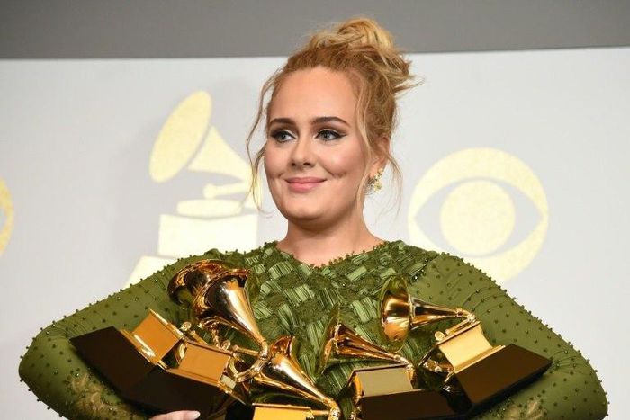 Adele holds five Grammy trophies, including the top two awards of the night, Album and Record of the Year for her blockbuster hit "Hello" and the album "25"