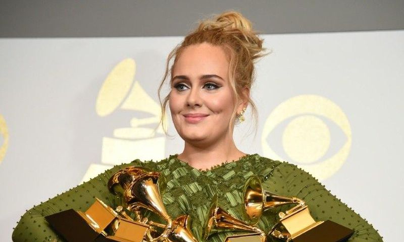 Adele holds five Grammy trophies, including the top two awards of the night, Album and Record of the Year for her blockbuster hit "Hello" and the album "25"