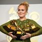 Adele holds five Grammy trophies, including the top two awards of the night, Album and Record of the Year for her blockbuster hit "Hello" and the album "25"