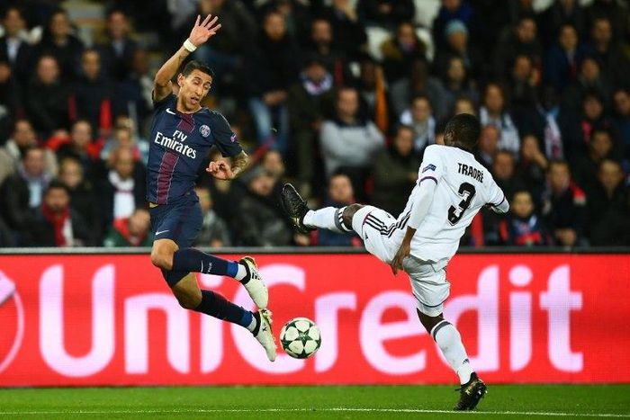 Paris Saint-Germain's forward Angel Di Maria (L) challenges Basel's defender Adama Traore during the UEFA Champions League group A football match between Paris Saint-Germain (PSG) and Basel at the Parc des Princes stadium in Paris on October 19, 2016