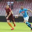 Roma's forward from Bosnia and Herzegovina Edin Dzeko (left) vies with Napoli's defender from Algeria Faouzi Ghoulam during their Italian Serie A match at the San Paolo stadium in Naples on October 15, 2016