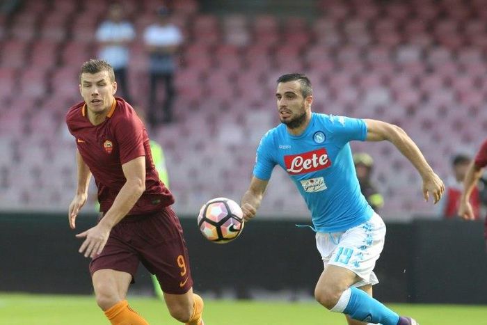Roma's forward from Bosnia and Herzegovina Edin Dzeko (left) vies with Napoli's defender from Algeria Faouzi Ghoulam during their Italian Serie A match at the San Paolo stadium in Naples on October 15, 2016