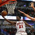 Jimmy Butler of the Chicago Bulls puts up a shot past Spencer Hawes of the Charlotte Hornets on his way to a game-high 52 points as the Bulls win 118-111