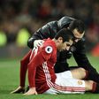 Manchester United midfielder Henrikh Mkhitaryan receives attention after picking up an injury during the English Premier League match against Tottenham Hotspur at Old Trafford on December 11, 2016