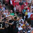 Liverpool players celebrate their first goal scored by midfielder Philippe Coutinho against Arsenal on August 14, 2016