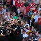 Liverpool players celebrate their first goal scored by midfielder Philippe Coutinho against Arsenal on August 14, 2016