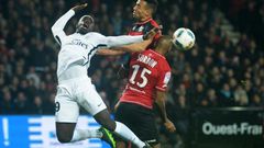 Paris Saint-Germain's Jean-Kevin Augustin (L) vies with Guingamp's Jeremy Sorbon (R) on December 17, 2016 at the Roudourou stadium in Guingamp, western of France