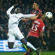 Paris Saint-Germain's Jean-Kevin Augustin (L) vies with Guingamp's Jeremy Sorbon (R) on December 17, 2016 at the Roudourou stadium in Guingamp, western of France