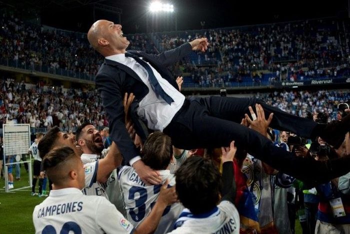 Real Madrid's head coach Zinedine Zidane is tossed by players
