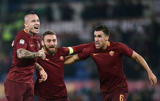 Roma's midfielder Radja Nianggolan (C) celebrates with teammates after scoring during the Italian Serie A football match Roma vs AC Milan at the Olympic Stadium in Roma on December 12, 2016