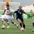 Guam's captain Jason Cunliffe (C) is challenged by Iranian players during an AFC qualifying match for the 2018 FIFA World Cup, in Tehran, in 2015