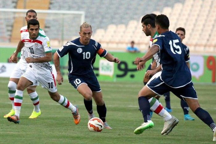 Guam's captain Jason Cunliffe (C) is challenged by Iranian players during an AFC qualifying match for the 2018 FIFA World Cup, in Tehran, in 2015