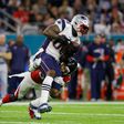 Martellus Bennett of the New England Patriots makes a catch against Deji Olatoye of the Atlanta Falcons on February 5, 2017