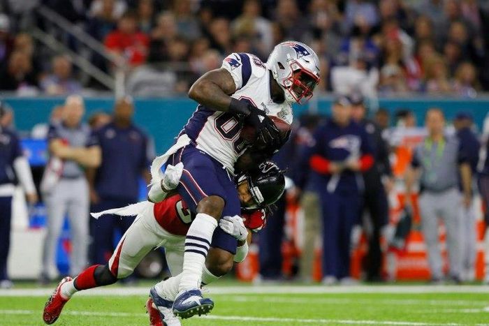 Martellus Bennett of the New England Patriots makes a catch against Deji Olatoye of the Atlanta Falcons on February 5, 2017