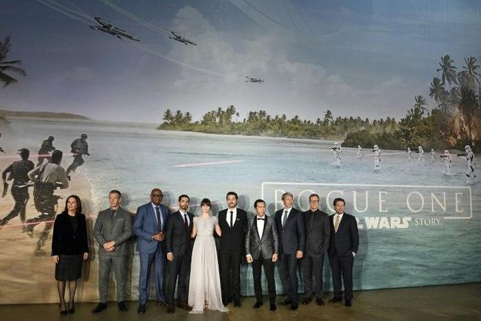 British actress Felicity Jones (C) poses with cast memebers upon arrival at the UK launch event of Lucasfilm's "Rogue One: A Star Wars Story", at the Tate Modern in central London on December 13, 2016