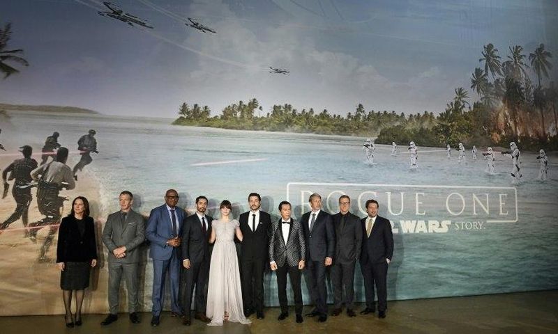 British actress Felicity Jones (C) poses with cast memebers upon arrival at the UK launch event of Lucasfilm's "Rogue One: A Star Wars Story", at the Tate Modern in central London on December 13, 2016
