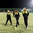 Dortmund's (from L) Raphael Guerreiro, Ousmane Dembele and Pierre-Emerick Aubameyang walk accross the pitch after their cancelled German Cup match against Sportfreunde Lotte due to heavy snowfall, in Lotte, on February 28, 2017