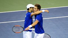 France's Pierre-Hugues Herbert (L) and Nicolas Mahut celebrate their their victory over Japan in the Davis Cup first round on February 4, 2017