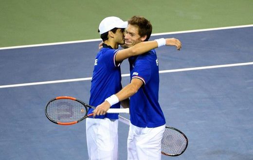 France's Pierre-Hugues Herbert (L) and Nicolas Mahut celebrate their their victory over Japan in the Davis Cup first round on February 4, 2017