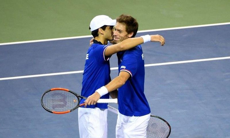 France's Pierre-Hugues Herbert (L) and Nicolas Mahut celebrate their their victory over Japan in the Davis Cup first round on February 4, 2017