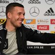 Germany midfielder Lukas Podolski answers journalists during a joint press conference with head coach Joachim Loew (unseen) in Dortmund, western Germany, on March 21, 2017