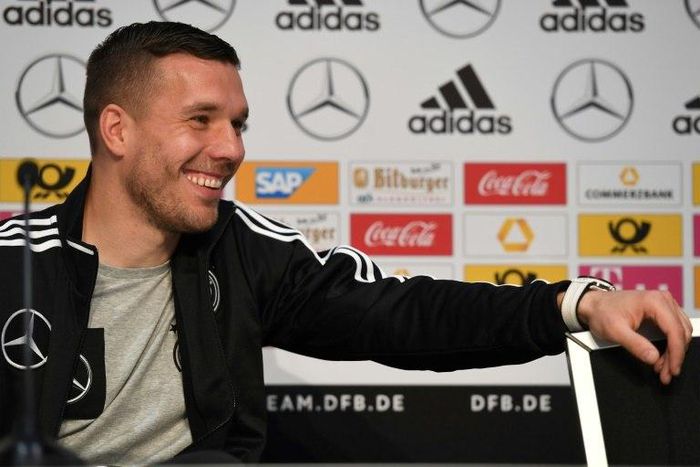 Germany midfielder Lukas Podolski answers journalists during a joint press conference with head coach Joachim Loew (unseen) in Dortmund, western Germany, on March 21, 2017