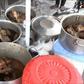A 'malewa' or street food sellers displays chicken stew at her stall in DR Congo's capital Kinshasa on February 12, 2017