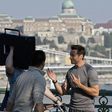Australian actor Hugh Jackman chats with crew members on the Szabadsag bridge in Budapest during a film shoot, in 2011