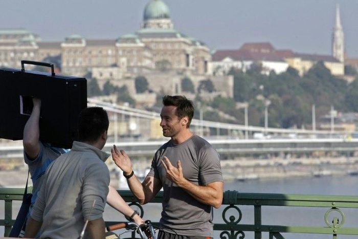 Australian actor Hugh Jackman chats with crew members on the Szabadsag bridge in Budapest during a film shoot, in 2011